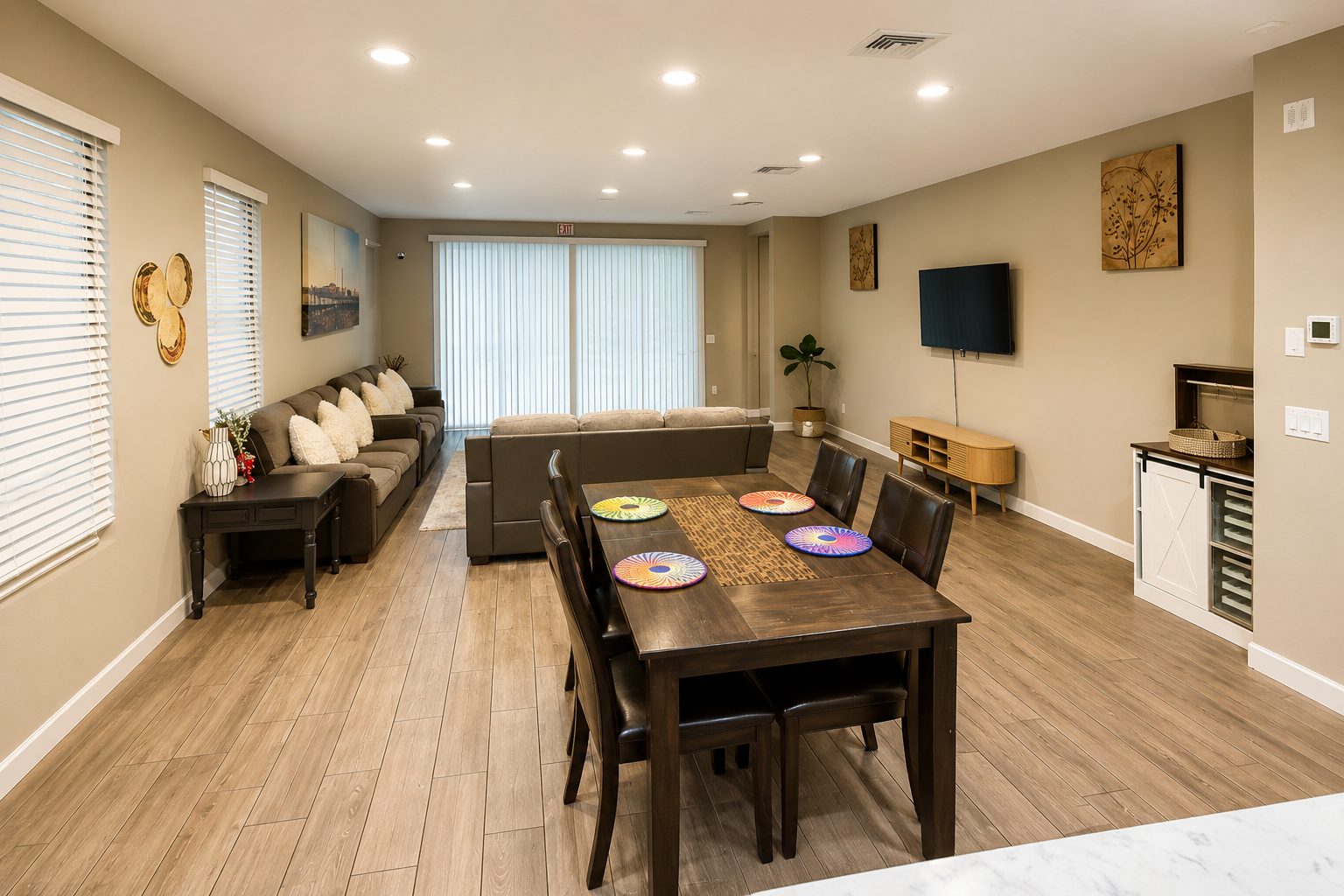 The open living and dining area at Agape Home, with sofas, a shared dining table and natural light
